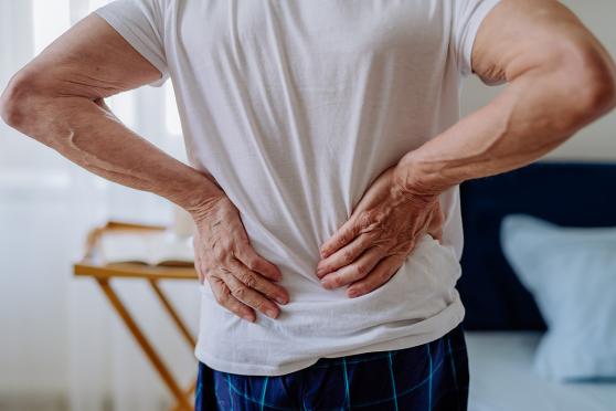 Man with his hands on his back